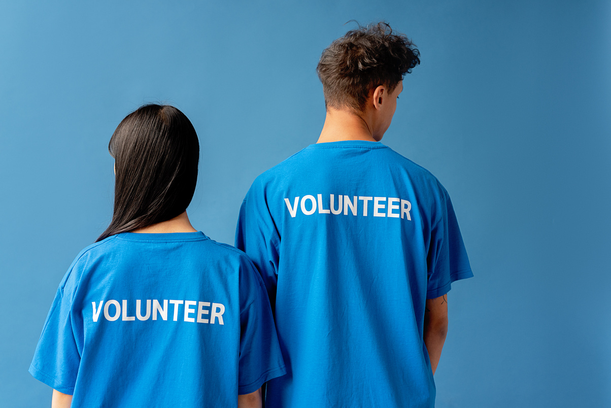 Man and Woman Wearing Blue Shirts With Printed Text